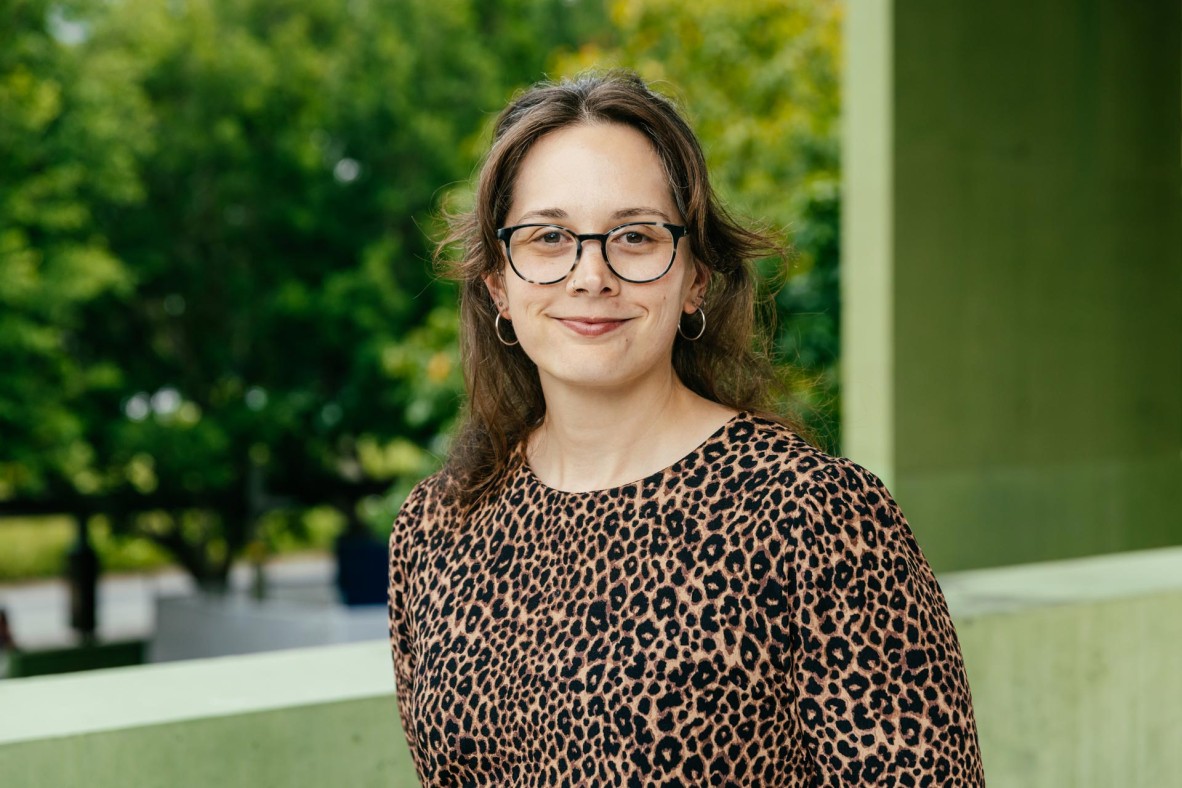 Woman outside, smiling at the camera.