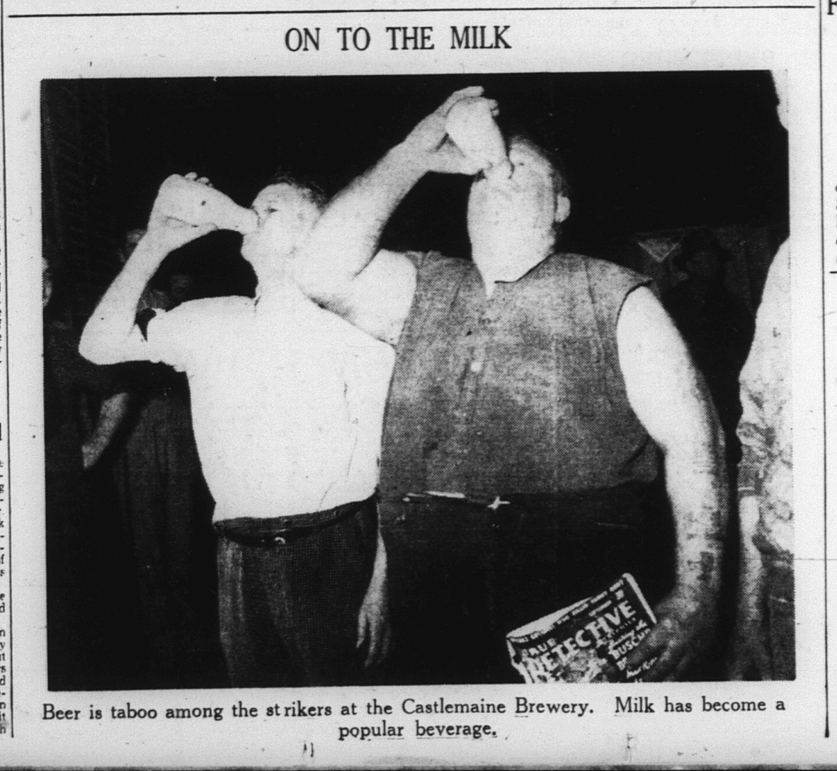 Black and white newspaper photo of two men in shirtsleeves drinking from bottles of milk. The headline above the photo reads 'ON TO THE MILK', which the caption reads: 'Beer is taboo among the strikers at the Castlemaine Brewery. Milk has become a popular beverage.
