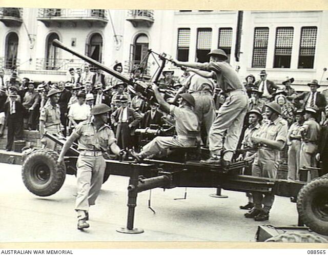 Bofors 40mm anti aircraft guns in ‘snap action’ during an army display in King George Square, Brisbane, 16 April 1945.