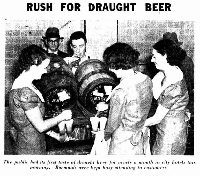 Black and white image of three women and two men crowding around two beer kegs. A headline reads: RUSH FOR DRAUGHT BEER, and a caption reads: 'The public had its first taste of draught beer for nearly a month in city hotels this morning. Barmaids were kept busy attending to customers.'