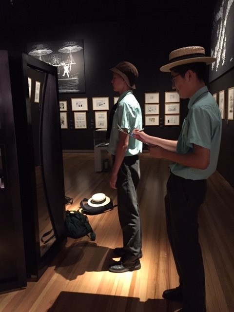 Two students standing at an exhibition