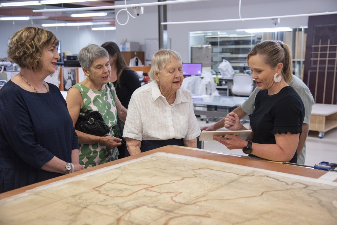 State Librarian and CEO Vicki McDonald, Dr Cathryn Mittelheuser, Senior Conservator Rachel Spano and Eddie Jose viewing map as it dries under tension on karibari. December 2018