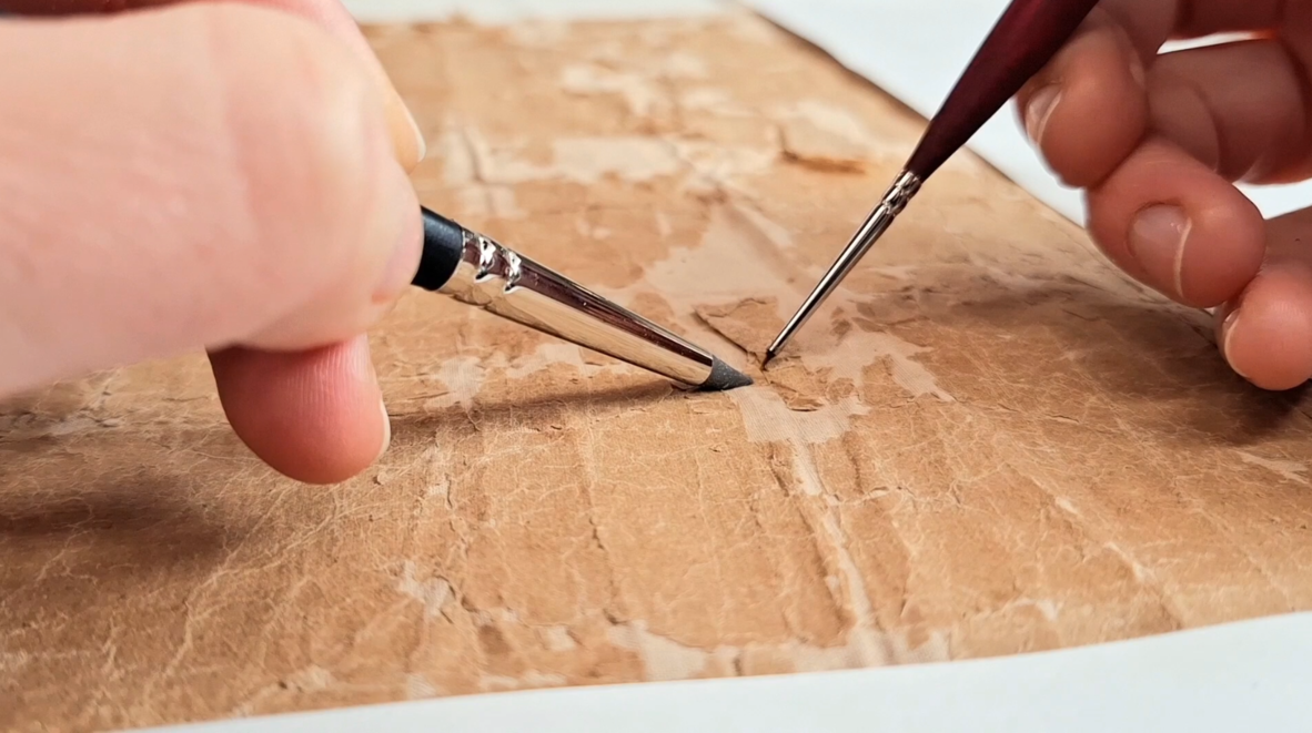 Re-adhering the fragments to the textile with wheat starch paste and a 0000 brush