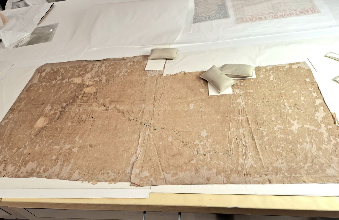 The map fully unfolded, revealing two pieces of fabric joined to create an L shape