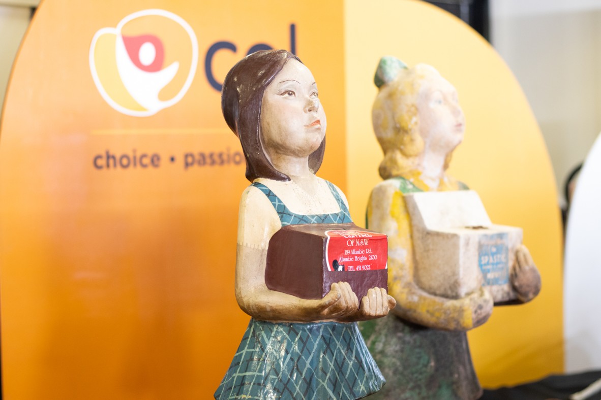 Two life-sized girl fibreglass donation boxes in the shape of young girls.
