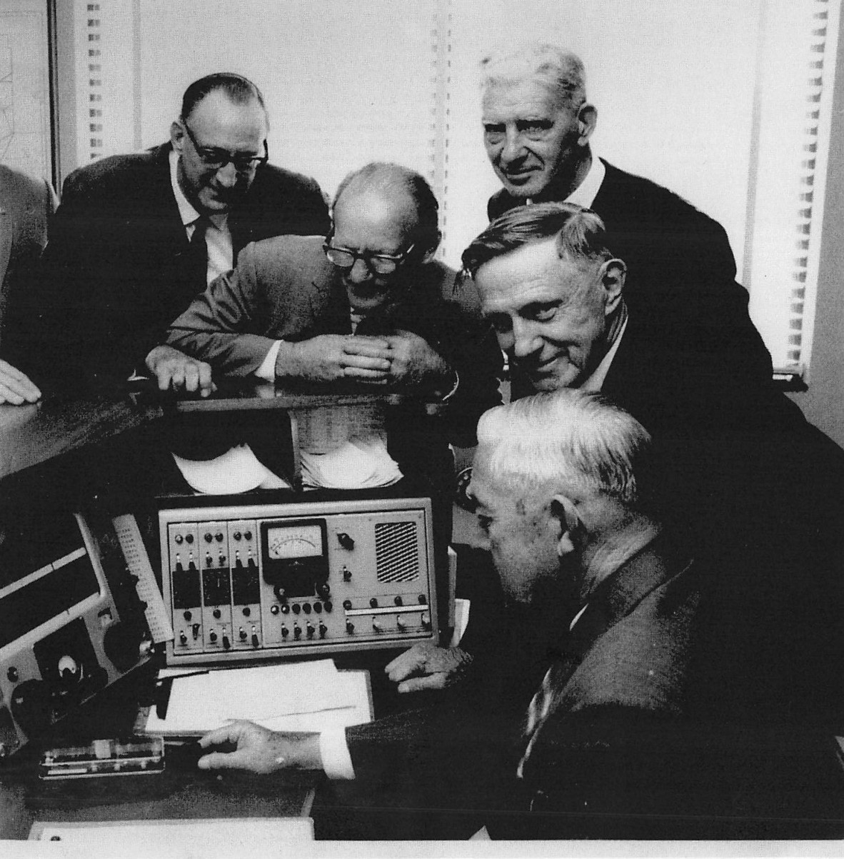 Sir Arthur Petfield (2nd from left) joins the onlookers as the then Postmaster-General, Me Alan Hulme (later Sir Alan) tries out a Morse key at the official opening of OTC’s Melbourne radio installation at Cape Schank on June 3, 1966.  