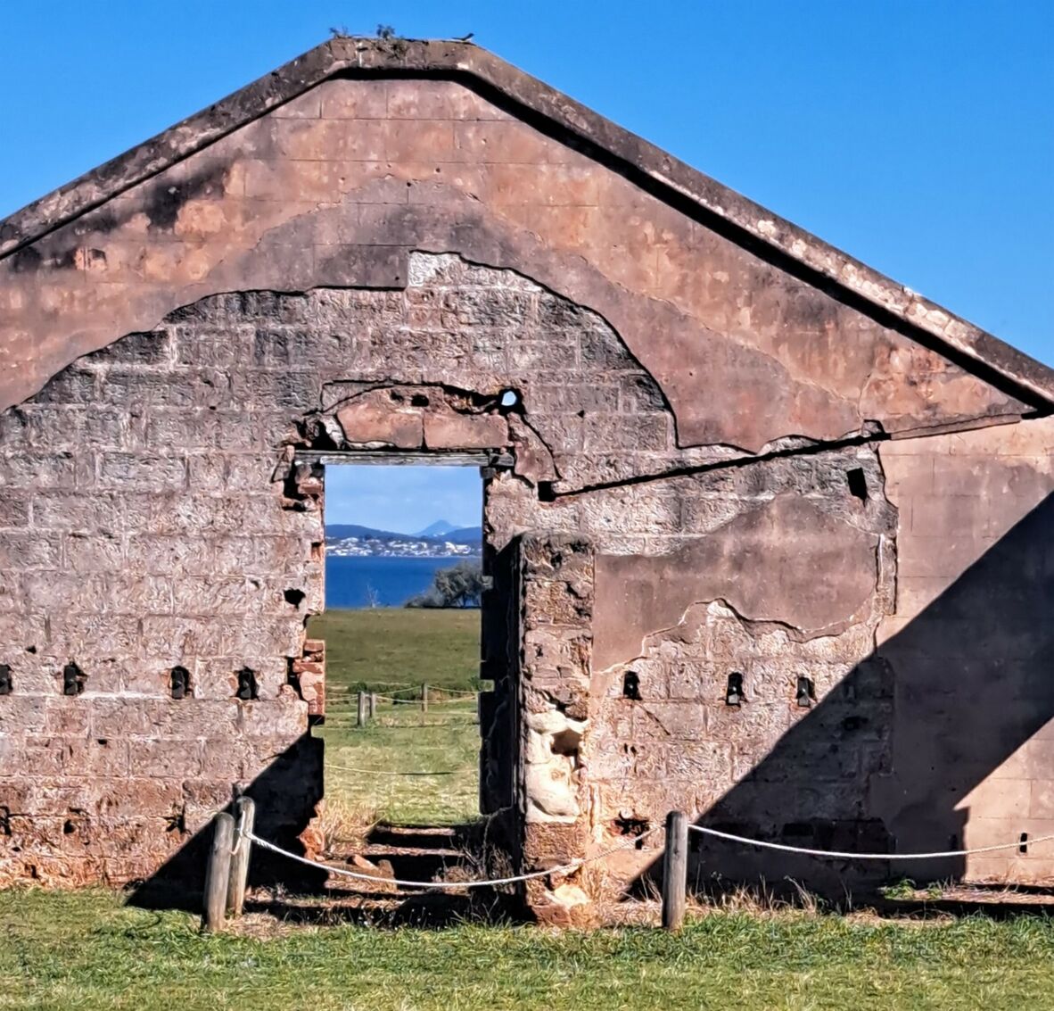 Photo of ruined cell block on St Helena Island with view of Brisbane in the distance