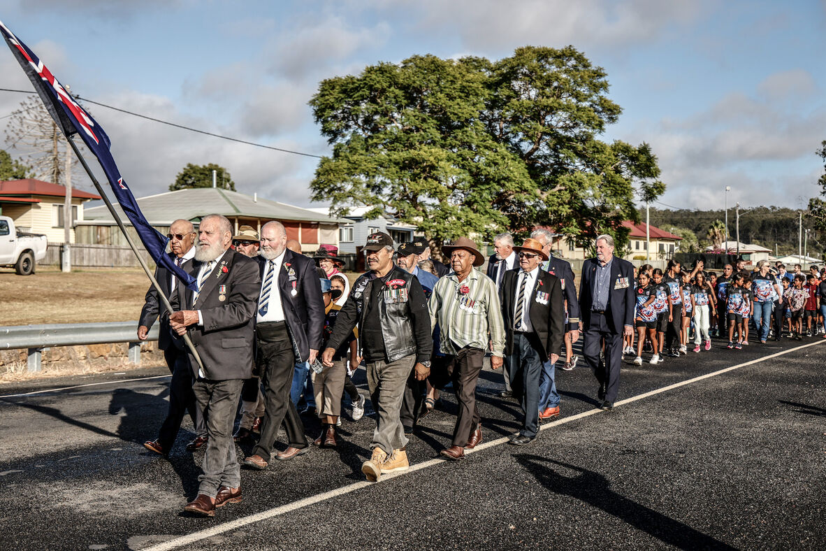 Cherbourg locals marching from the middle of town to the Anzac monument in 2023.