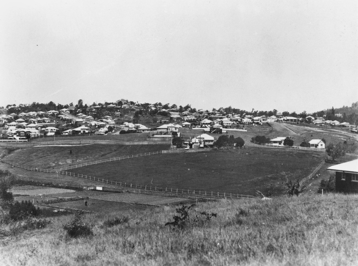 A view over a field surrounded by houses