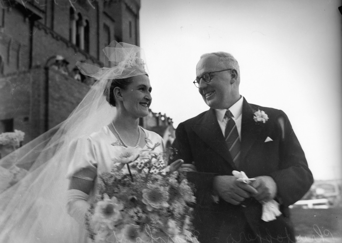 Black and white photograph featuring a bride and groom, outside of a church in 1940.