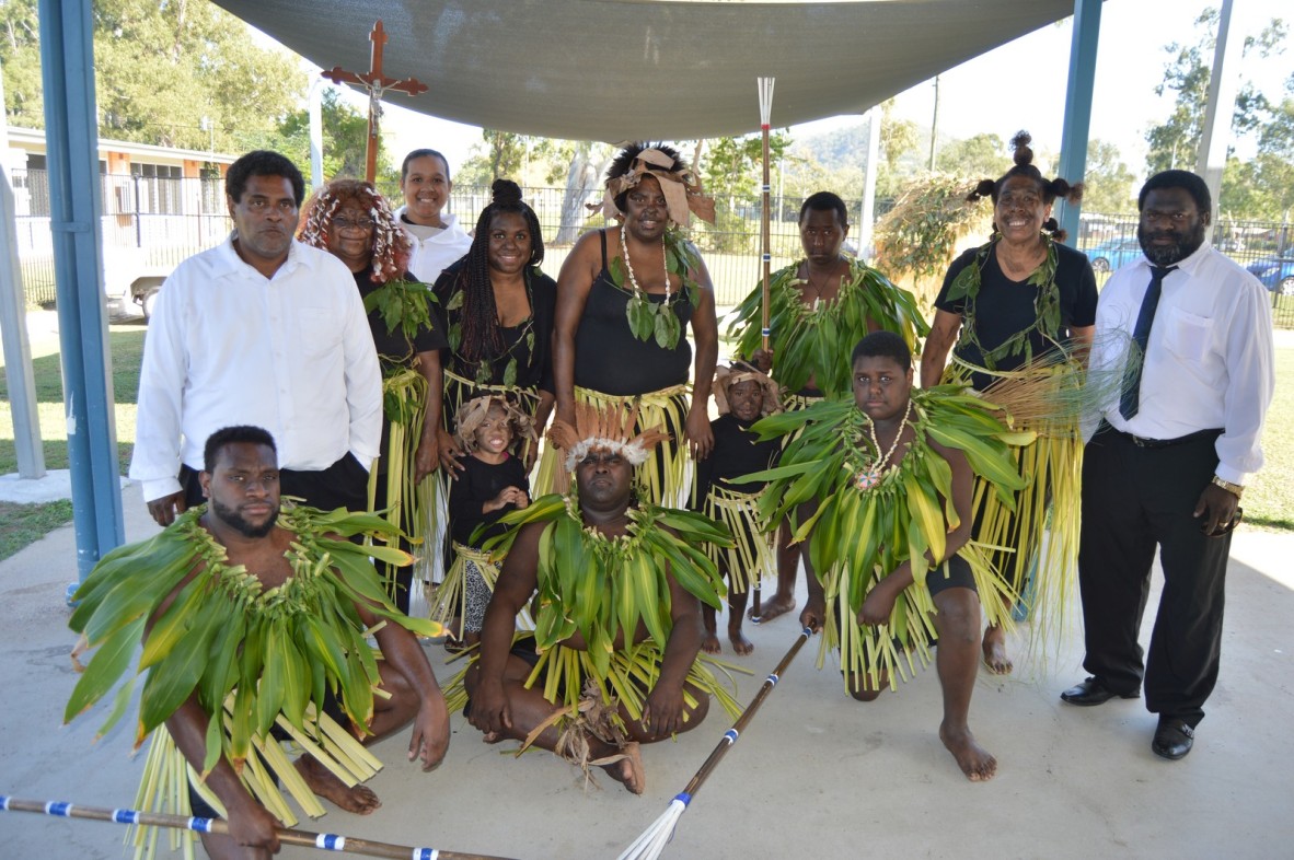 Church ministers with group of people in costume for the Coming of the Light Festival, Erub Island, 1 July 2016.