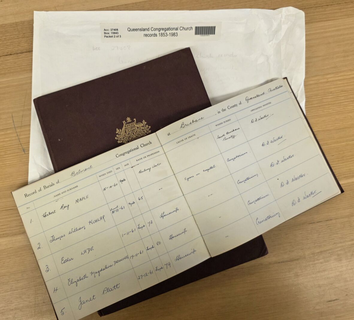 Queensland Congregational Church record book open on a page, laying over another book