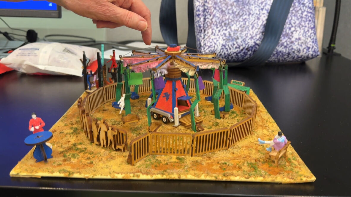 A photo of a miniature windjammer sideshow ride
