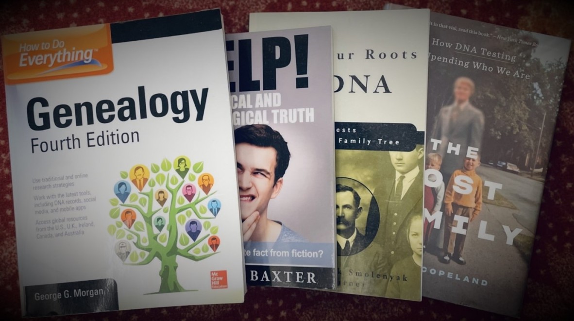 Photograph of four books about genealogy and genetic testing