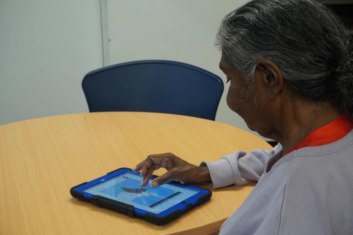Woman using an ipad to view State Library webpage