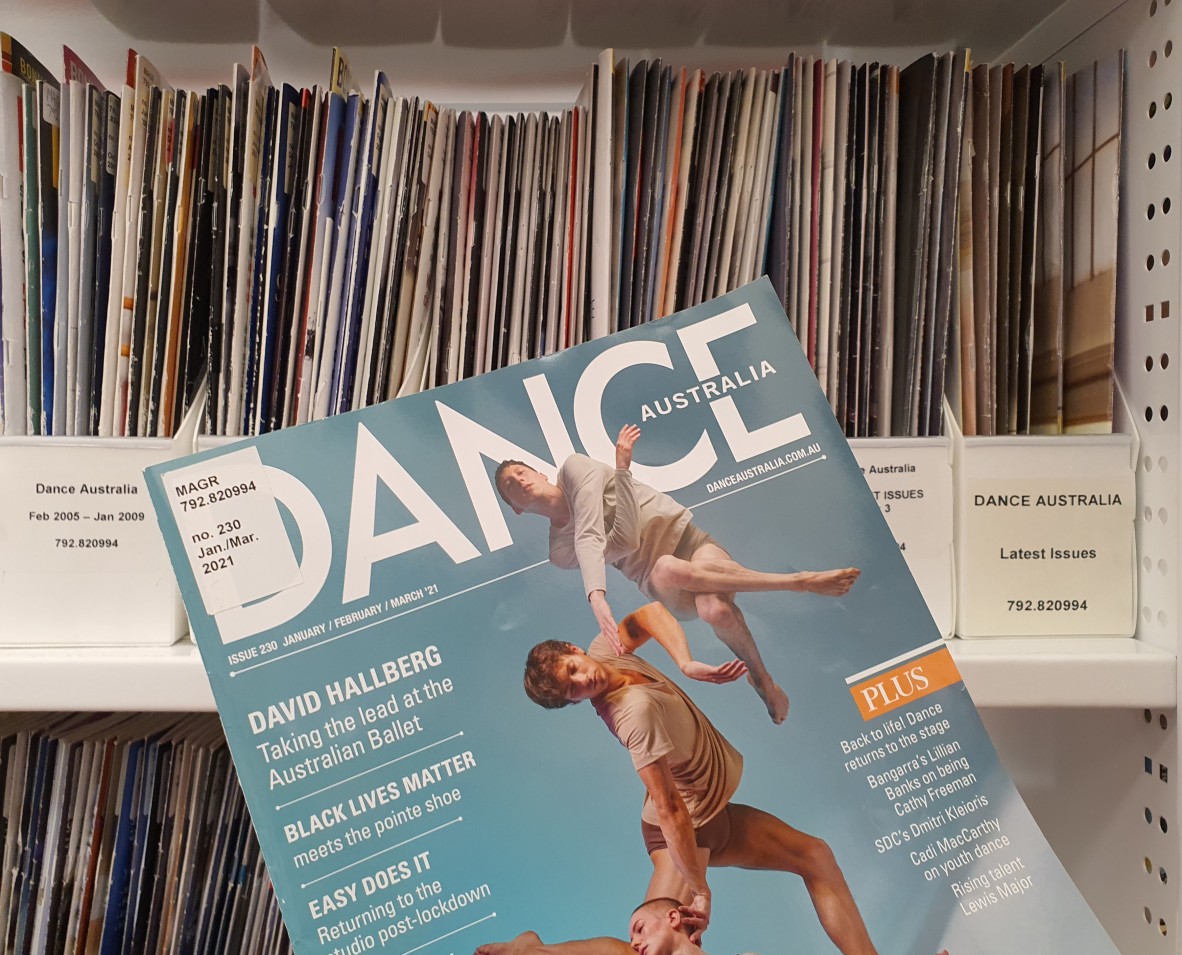 An issue of Dance Australia magazine in front of a library shelf