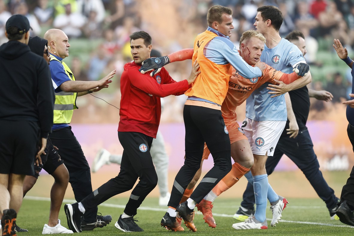 A photo of footballers on the field in a scuffle