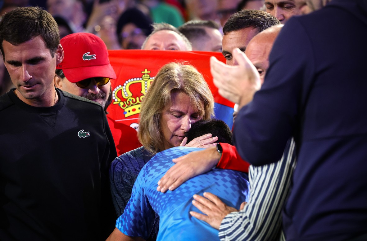 A photo of a mother comforting her tennis player son