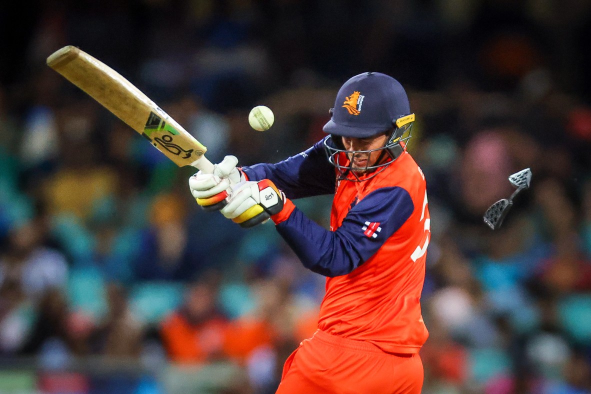 A cricketer hitting a ball with cricket bat