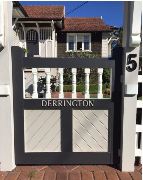 Colour photo of timber gate with house name Derrington