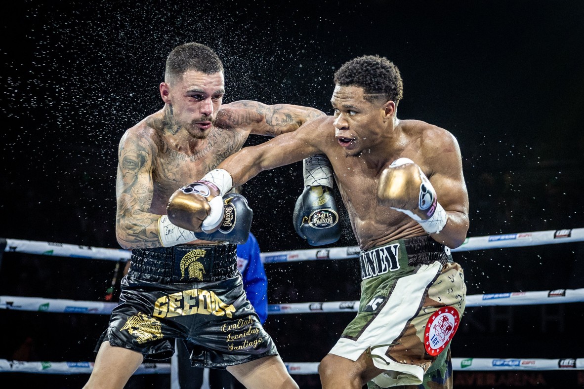 A photo of two boxers, Devin Haney landing a punch against George Kambosos