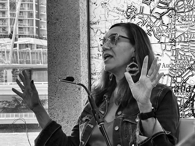 A black and white image of Dr Anita Heiss speaking at Brisbane Writers Festival in 2021. 