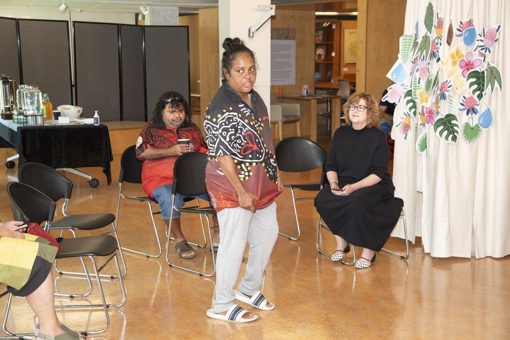 Community member speaking about her shirt design while the State Librarian and CEO listens on.