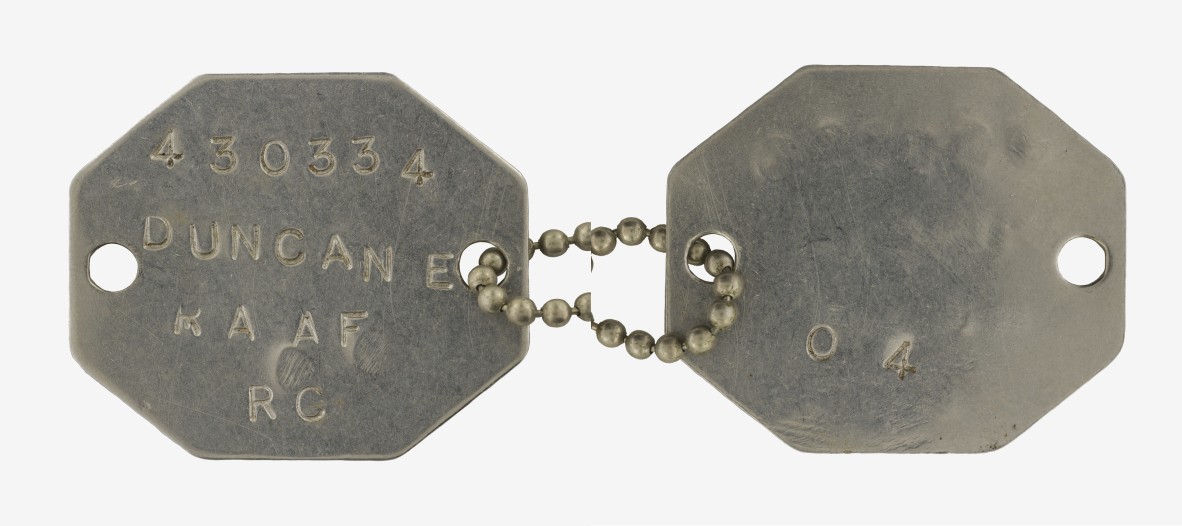 WWII RAAF hexagonal identity disc. It reads '230334 DUNCAN E RAAF RC O4.'