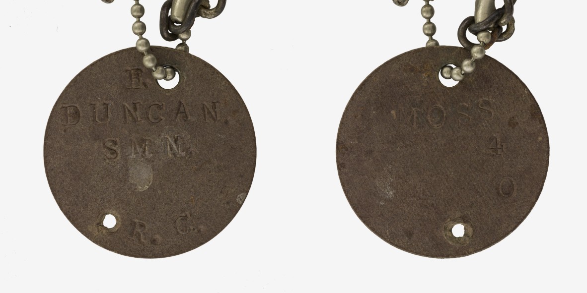 A WWII RAN identification disc. It reads 'E. DUNCAN. SMN R.C. MOSS O4.'