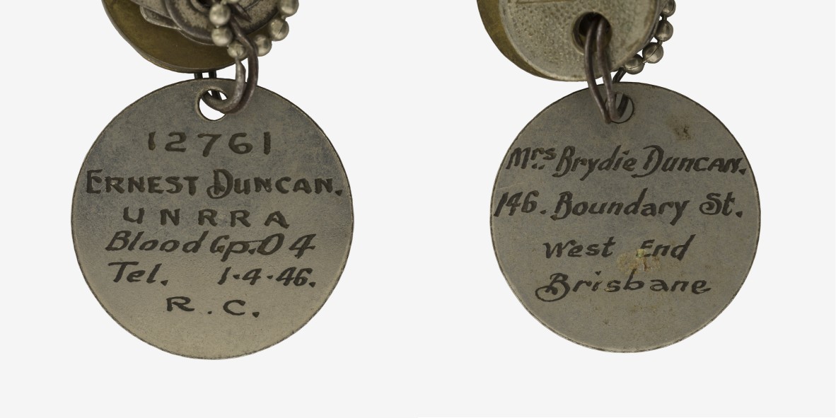 A circular identity disc used by Ernest Duncan while serving with UNRRA.