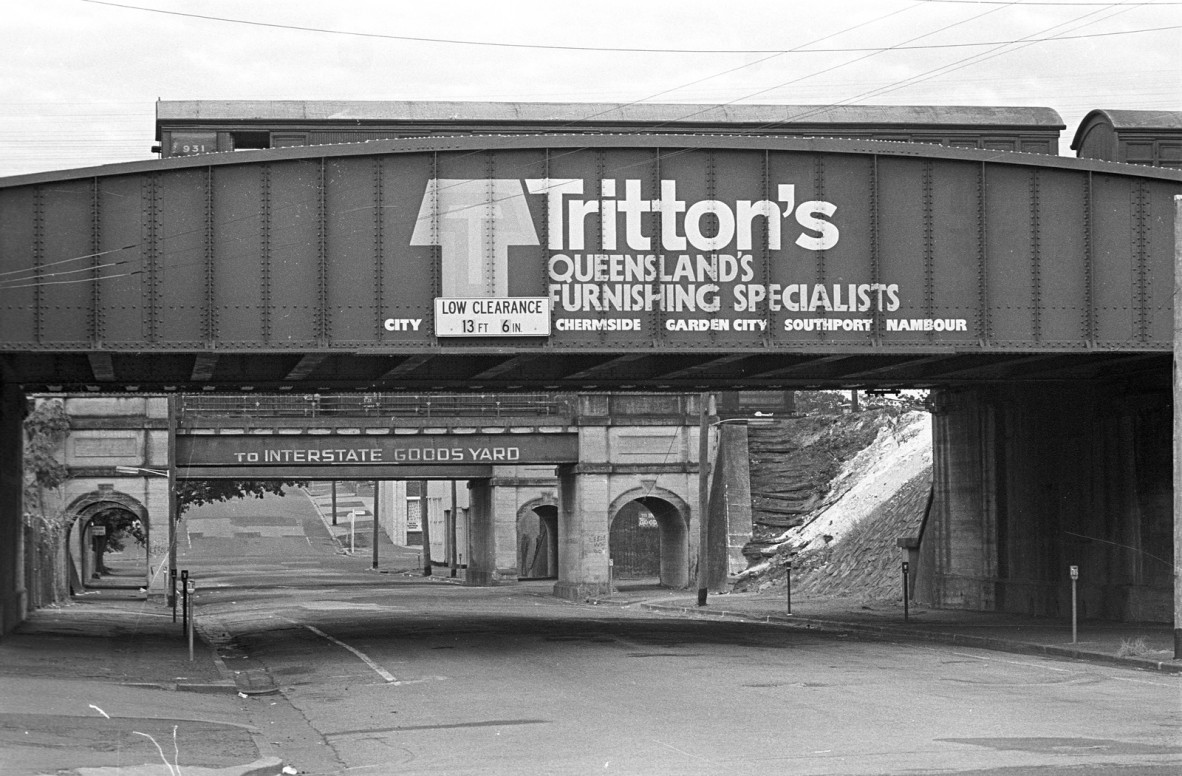 Advertising for Tritton's furniture stores on a railway bridge at South Brisbane, 1977. Colin Aggett, photographer. 32061 Colin Aggett photographs of Brisbane and surrounds.