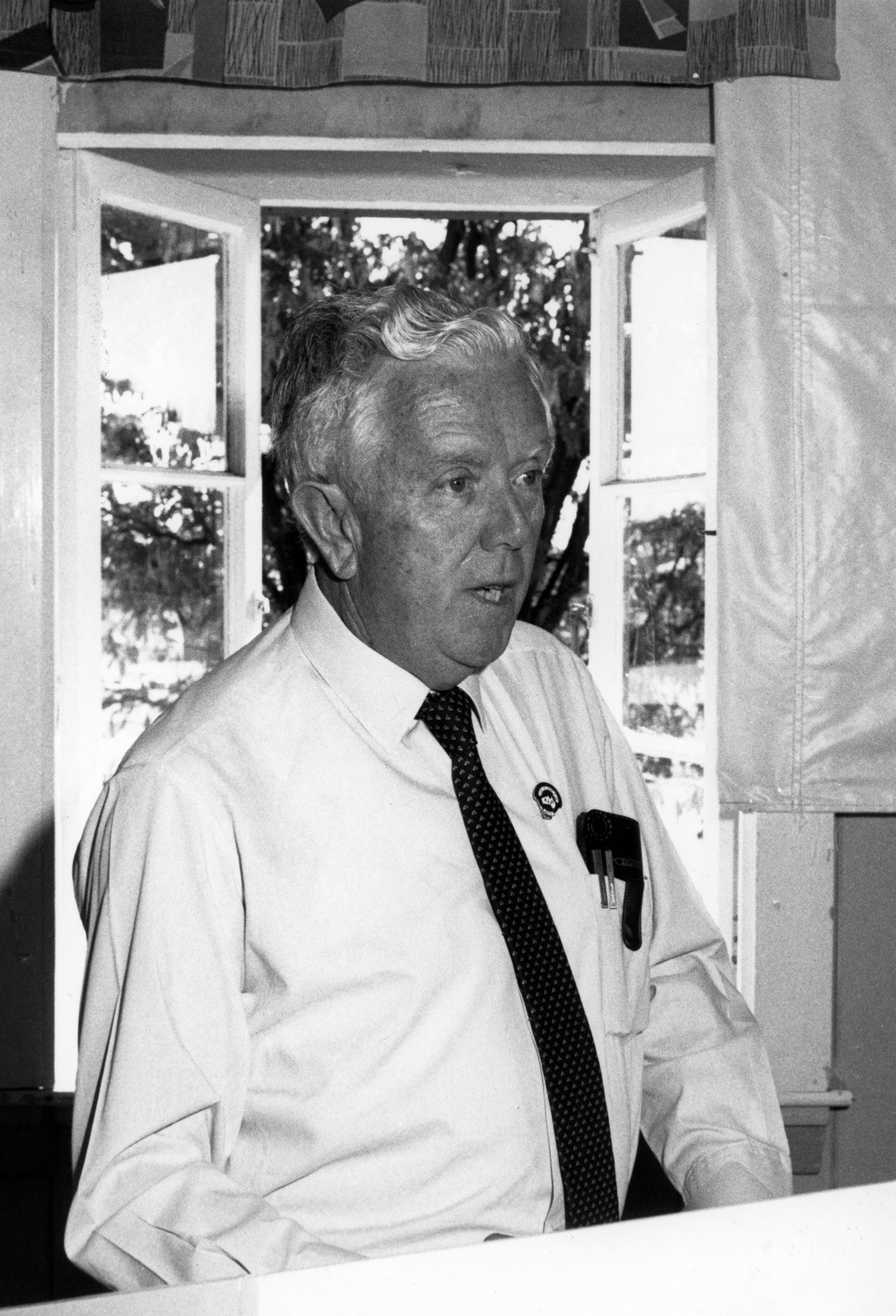 Manfred Cross standing at a podium addressing the Australian Workers Union meeting in Barcaldine, Queensland, 1991