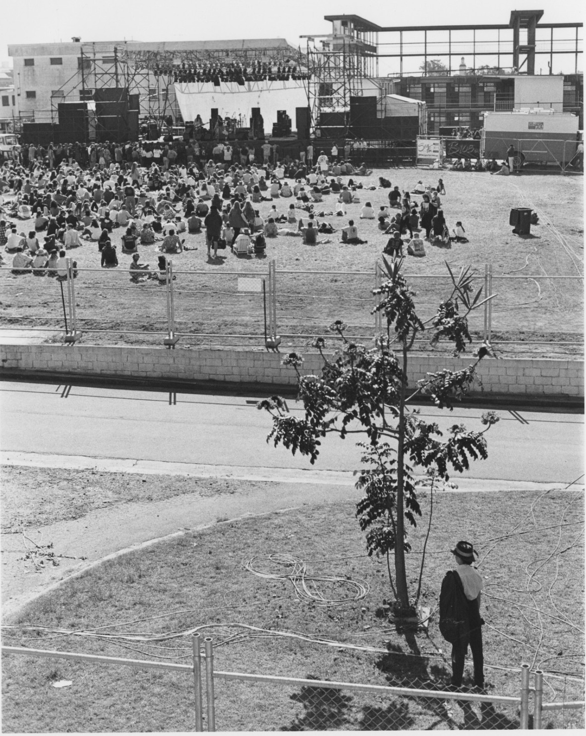 Photography by Kathy Dora. View of the crowd and stage at the Jailhouse Rock concert held at Boggo Road Gaol in Dutton Park, Brisbane, 1993. In copyright. John Oxley Library, State Library of Queensland. Image 27175-0001-0006