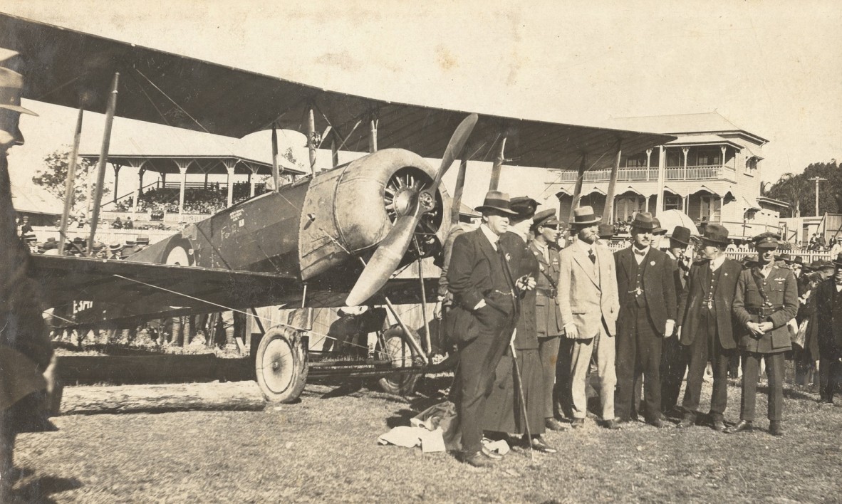 Flight Commander Francis Smith and the Peace Loan Committee with the Peace Loan biplane at Kedron Racecourse, 1919