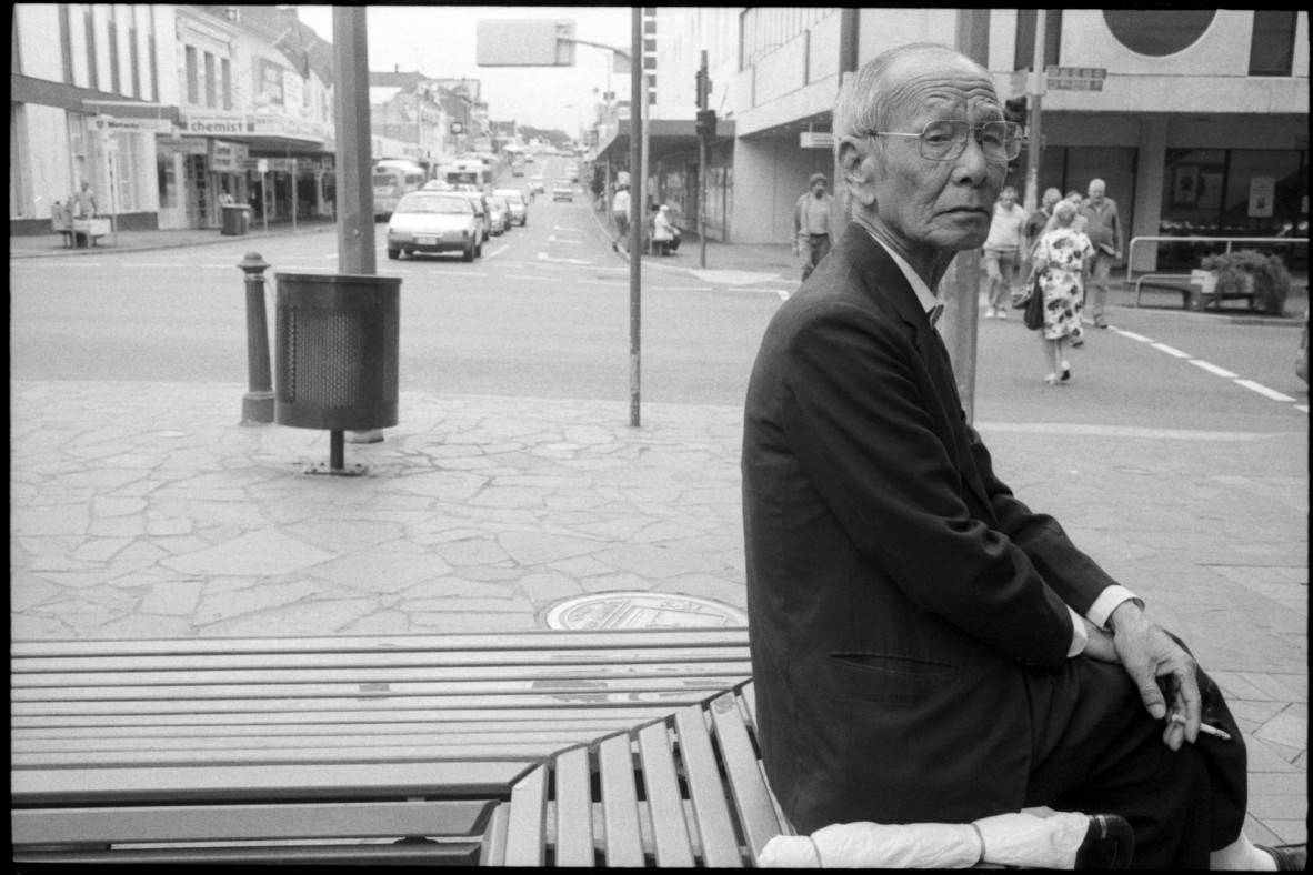 Elderly Chinese man sitting on the corner of Wickham Street, Fortitude Valley, ca. 1990-1999.
