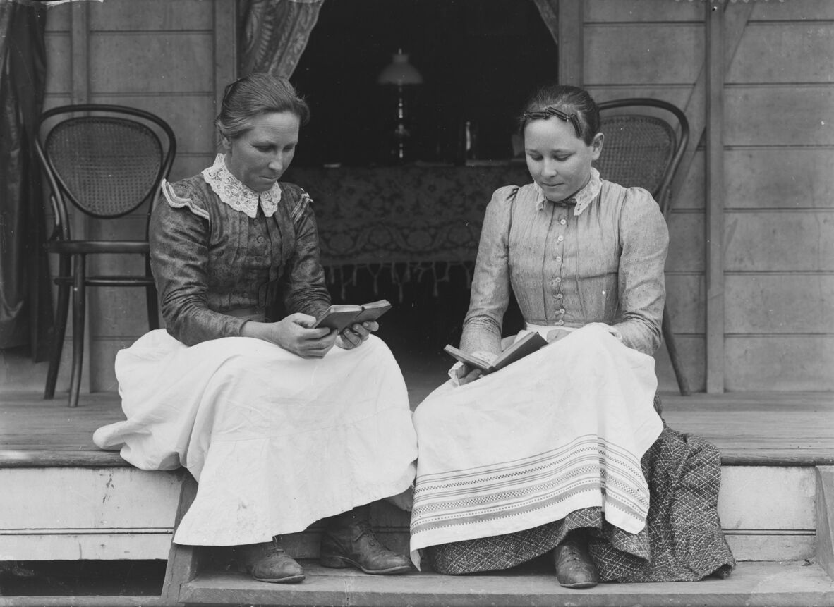 Harriett Brims reading a book on her verandah in Ingham, Queensland, ca. 1894-1903