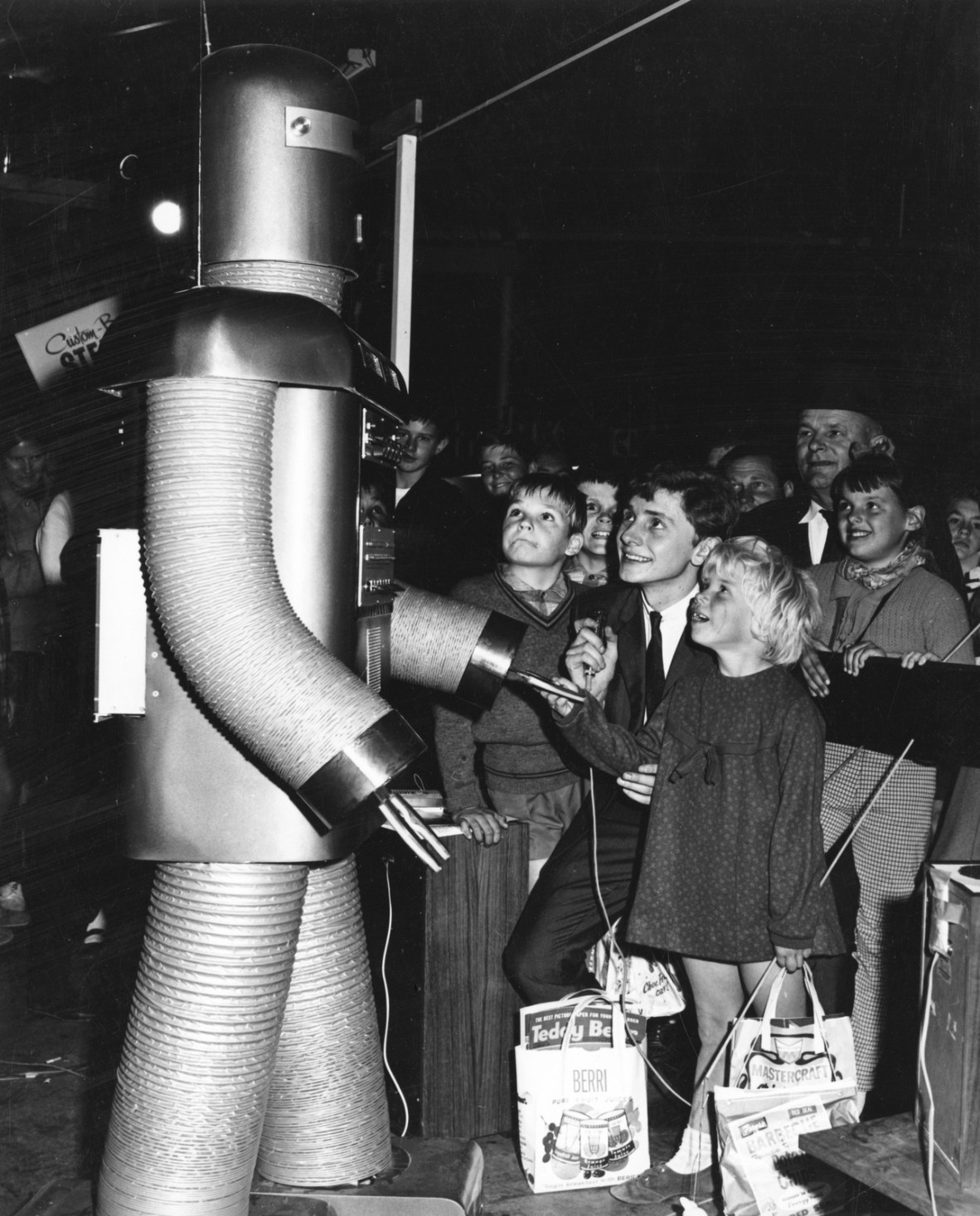 An old photograph of children enthralled by a giant robot at the Ekka in Brisbane