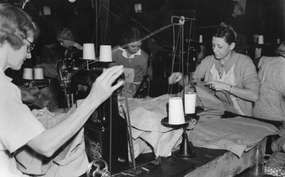Clothing industry workers sewing military uniforms