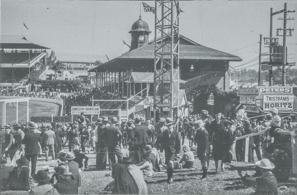 Men, women and children on the hill beside the grandstand at the Royal National Show, Bowen Hills, 1935-1940.