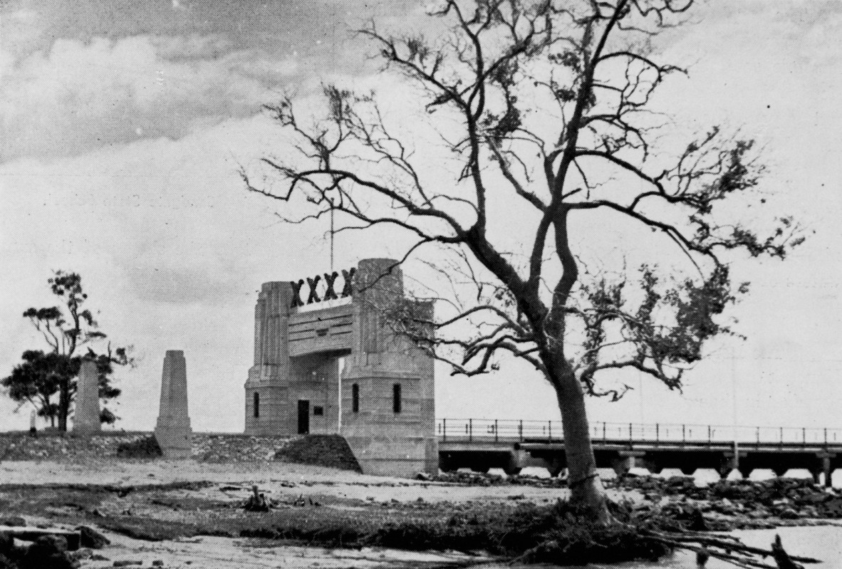 Entrance to the Hornibrook Highway from Sandgate, Brisbane, 1939. Pylons to mark the entrance to the Hornibrook Highway. The Fourex Brewery sign is above the gateway.
