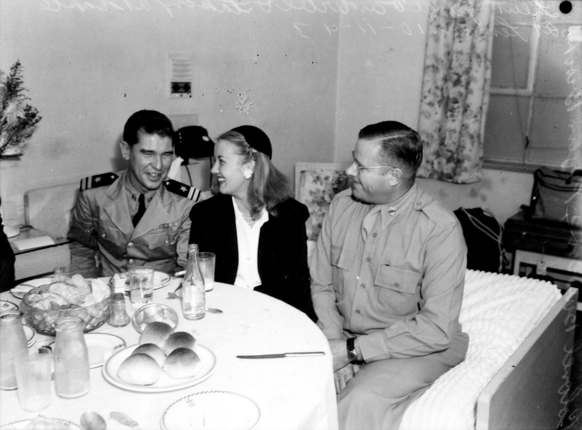 American film star Phyllis Brooks, at lunch with servicemen in a suite at Lennon's Hotel, Brisbane, November 1943. 