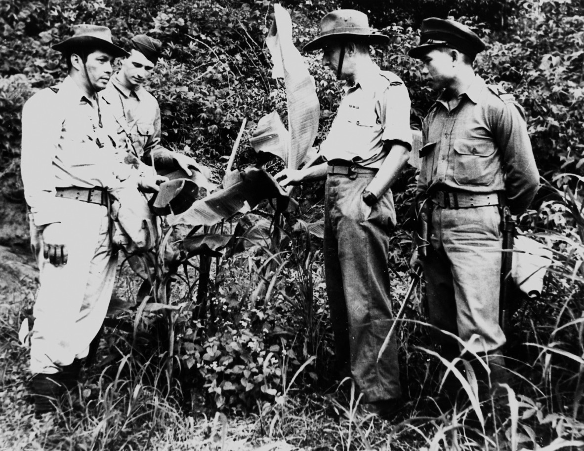 Old photograph of 4 male soldiers standing in a group outside.