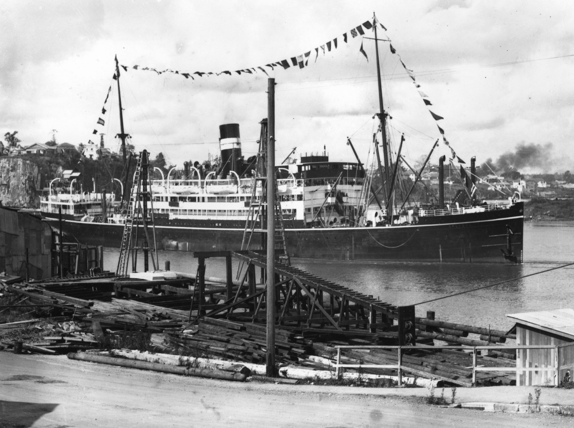 Old photograph of a ship in a wharf.