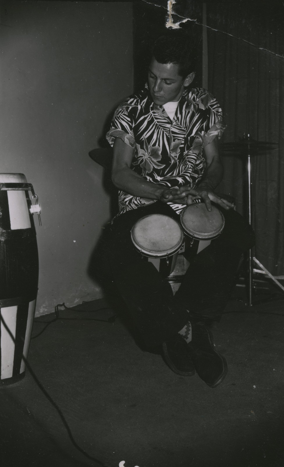 Buzz Ennis plays the bongos at the Primitif Cafe