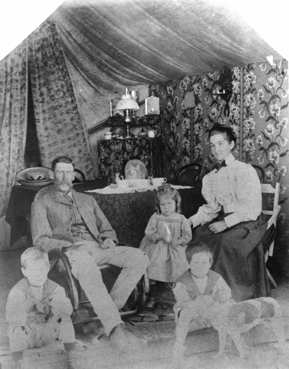 Family portrait taken inside a tent, Mt. Garnet, North Queensland, ca. 1905.