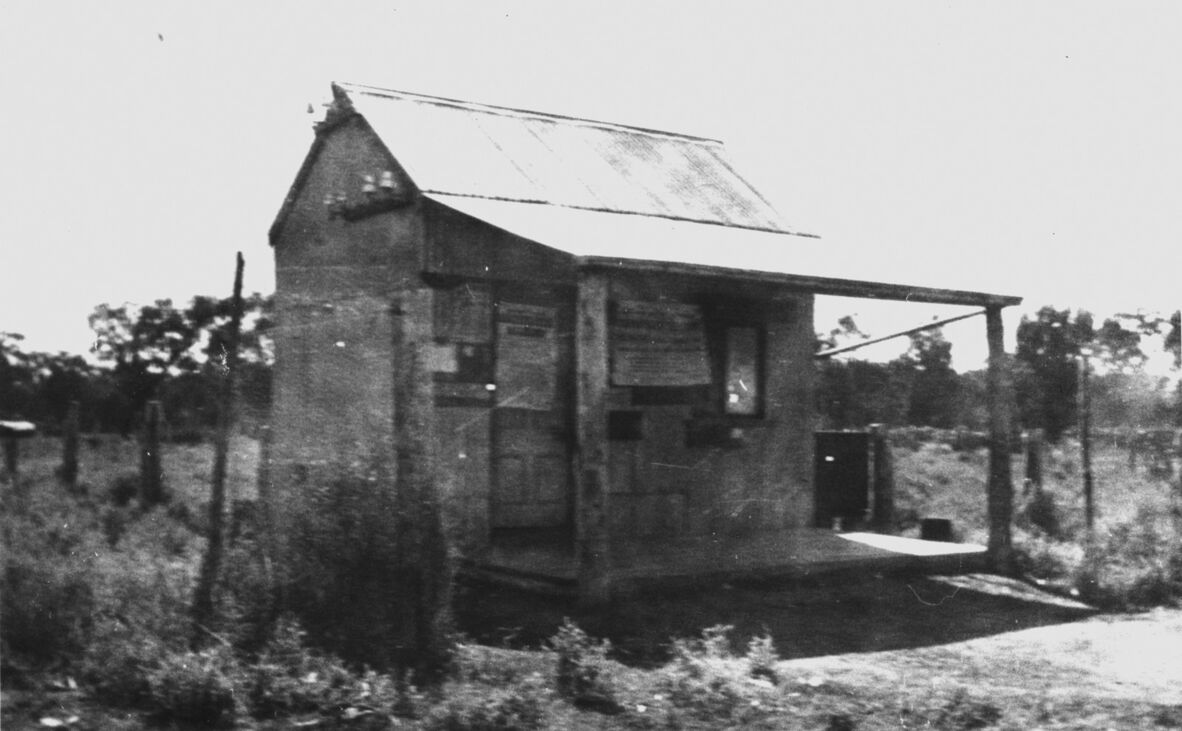 Black and white photograph of Nindigully Post Office, a small timber building with a small verandah.