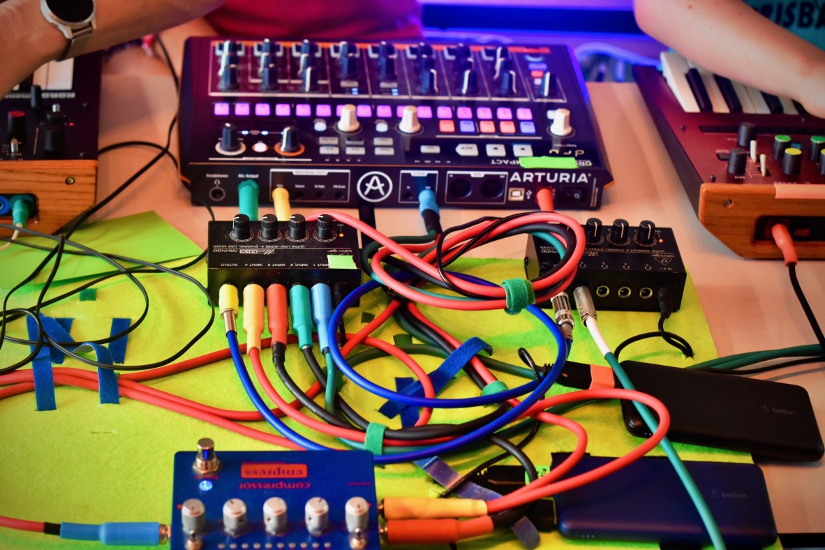 Patch cables and synths laid out on a table