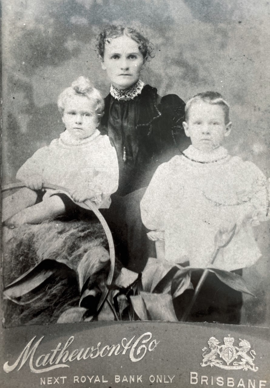 Copy of studio portrait George Weeks seated with his brother and their mother Annie