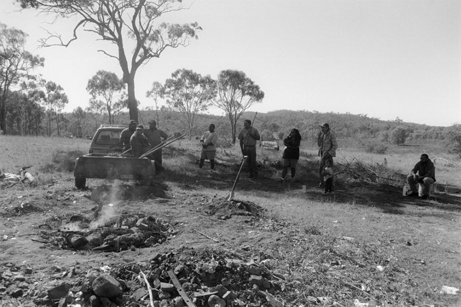 Group of Australian South Sea Islander men watching the hungi pit in Lakes Creek Rockhampton Queensland