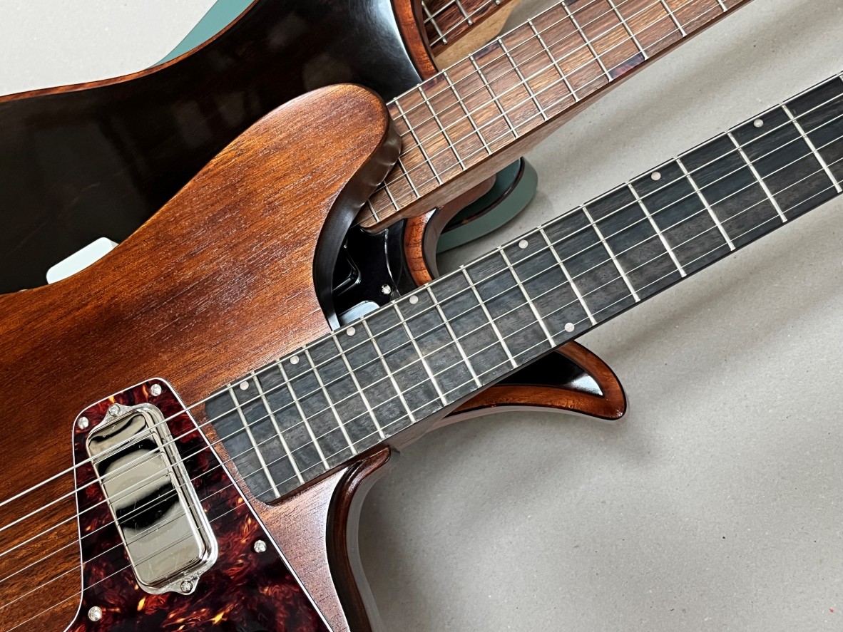 A photo of two guitars made by Wrecker Guitars